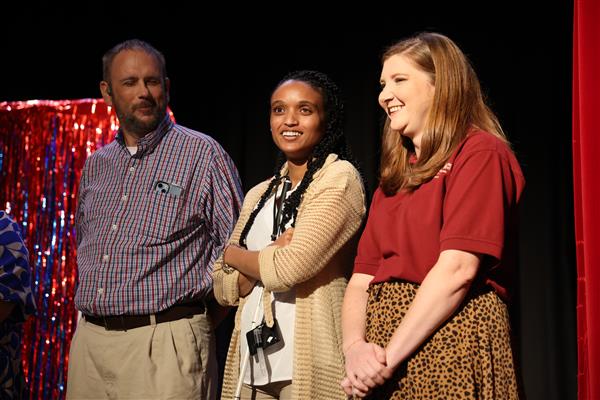 Three employees smile during AIDB says.
